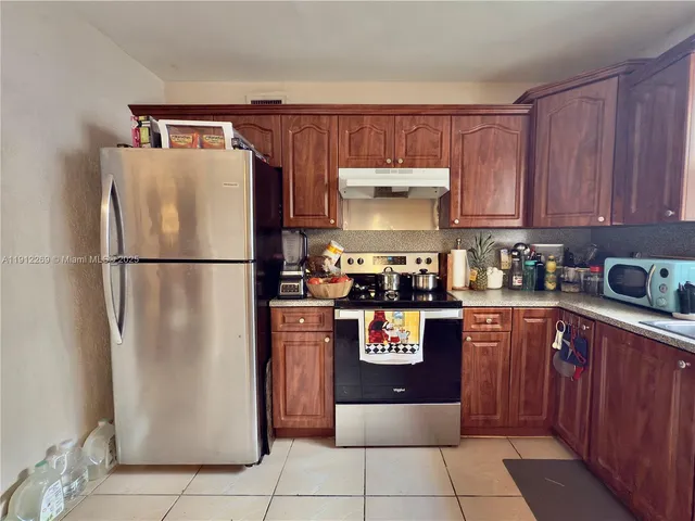 a kitchen with a refrigerator and a sink