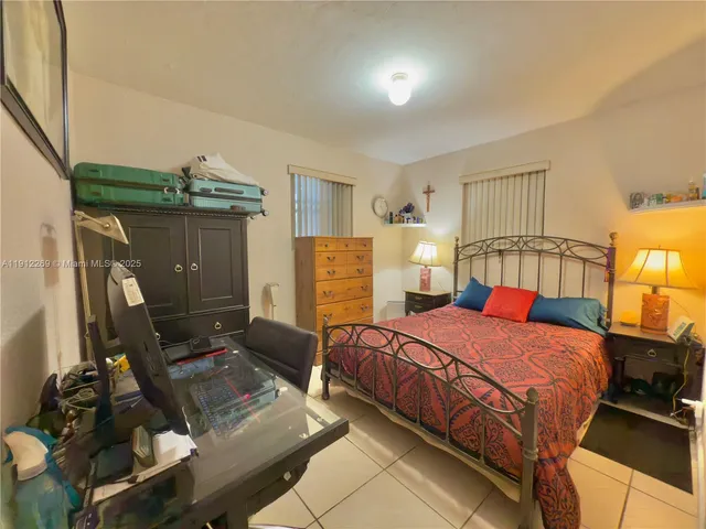 a bedroom with two beds and a flat screen tv