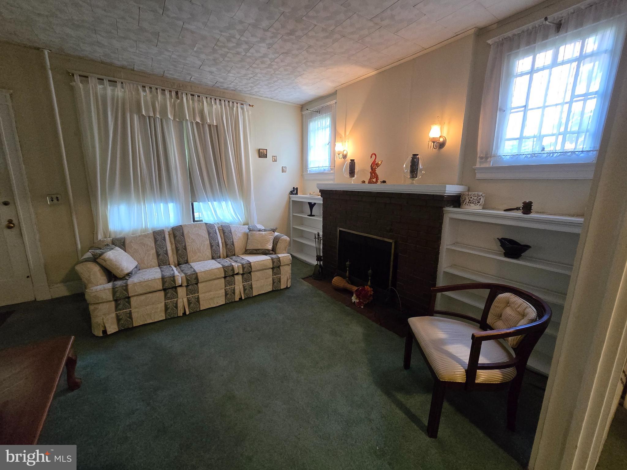 5533 Gwynn Oak Baltimore, MD 21207 - Photo 18 of 44 a living room with furniture and a fireplace