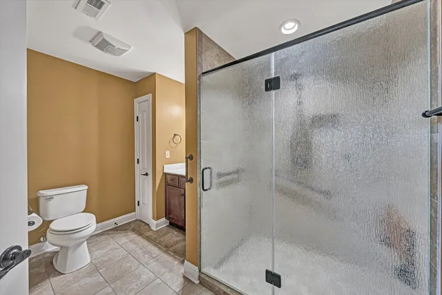 a bathroom with a shower and a toilet