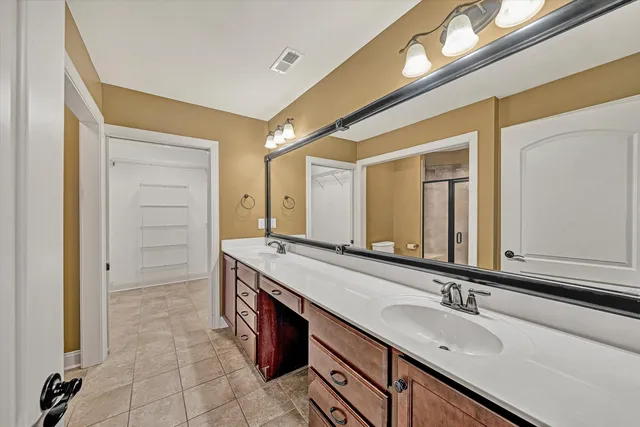 a bathroom with a granite countertop sink mirror and