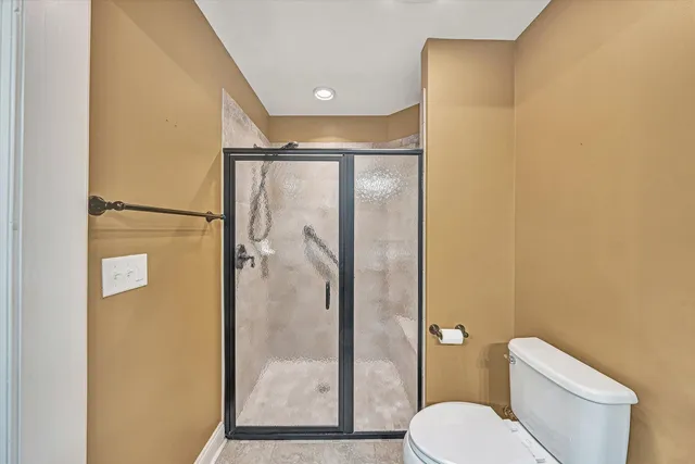 a bathroom with a toilet and a shower