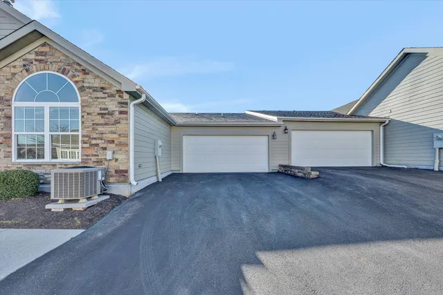 a view of a house with a wooden bench and floor to ceiling window