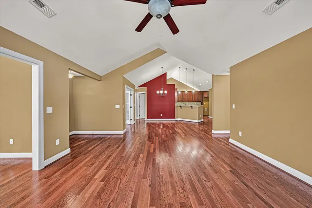 a view of a room with wooden floor and white walls