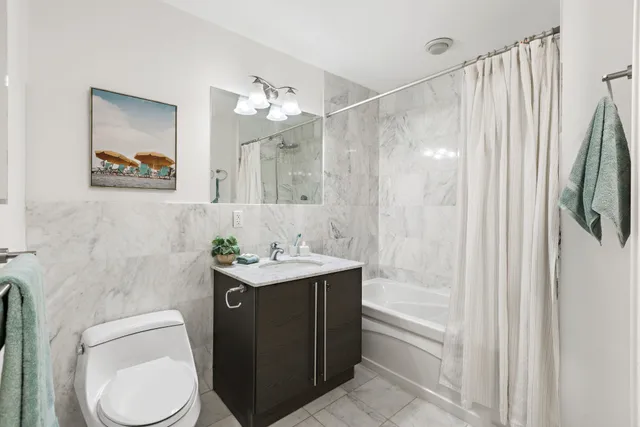 a bathroom with a toilet a sink and a mirror