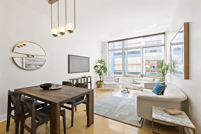 a living room with furniture a table and a large window