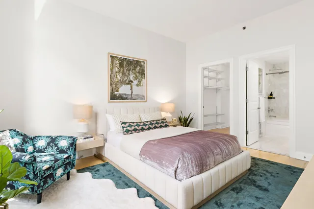 a bedroom with a bed and a couch