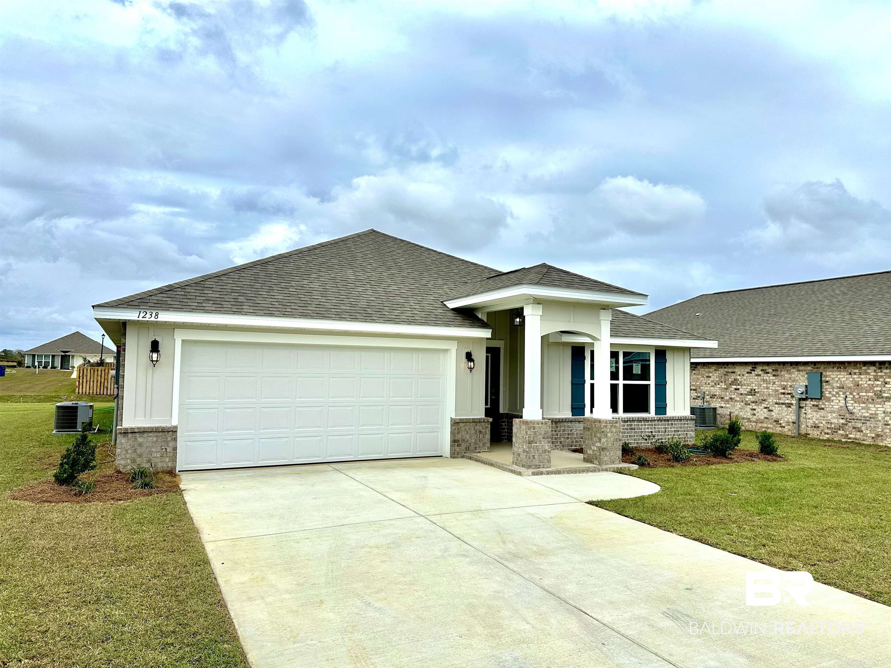 1238 Hayward Loop Foley, AL 36535 - Photo 3 of 46 Prairie-style house with central AC unit, a garage, and a front lawn