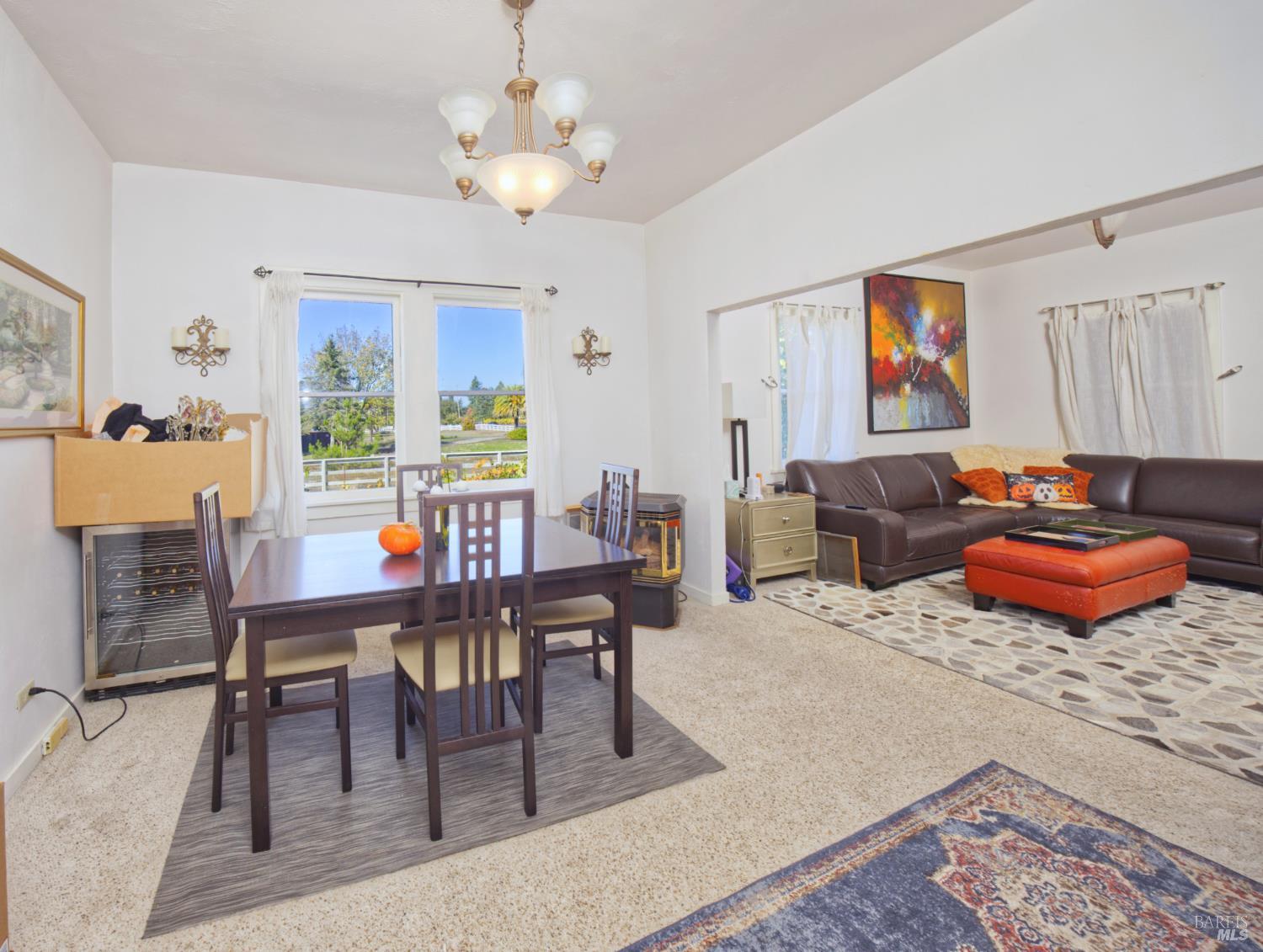 1623 Willowside Road Santa Rosa, CA 95401 - Photo 13 of 47 a living room with furniture a rug and a chandelier
