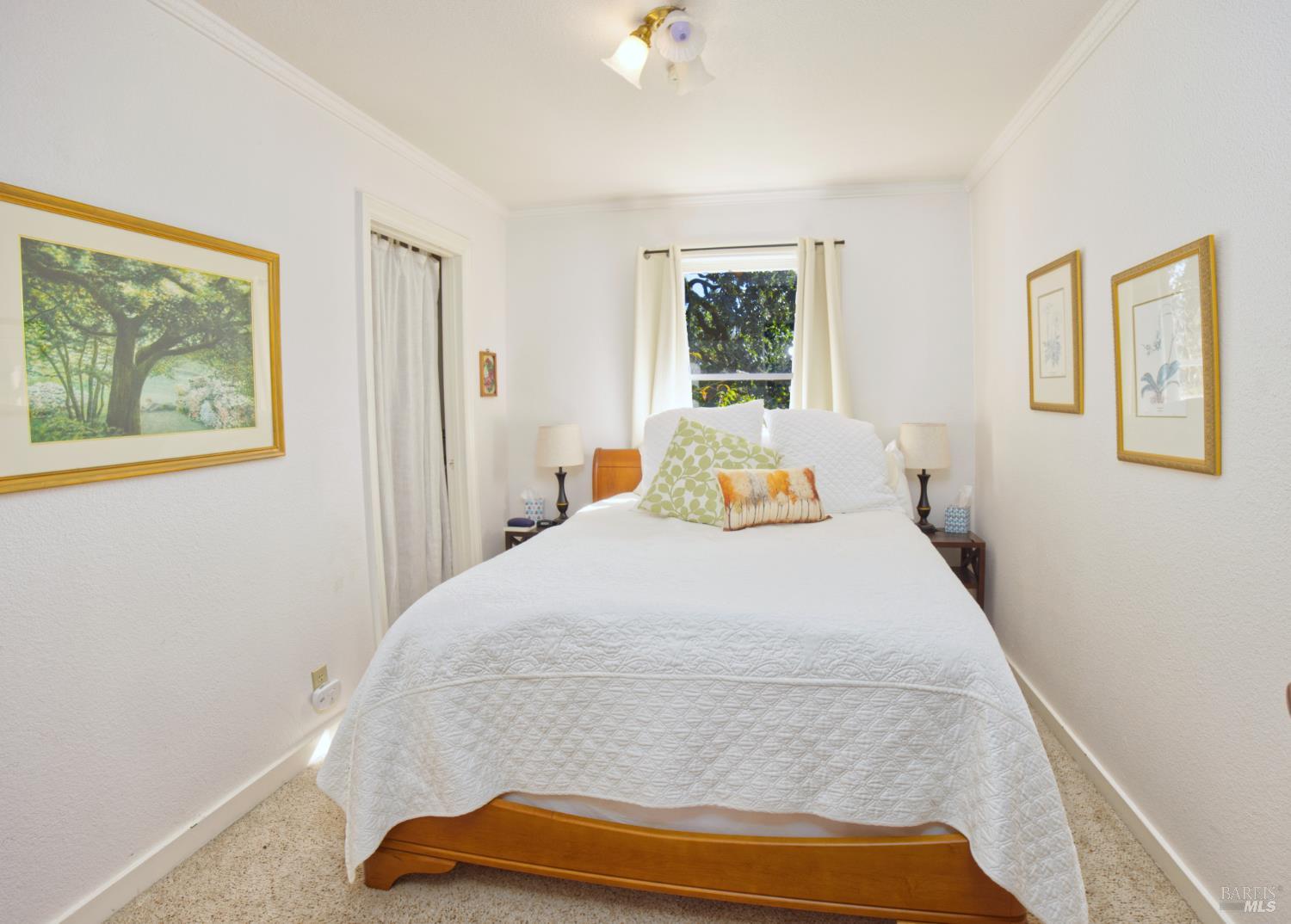 1623 Willowside Road Santa Rosa, CA 95401 - Photo 17 of 47 a bedroom with a bed and wooden floor