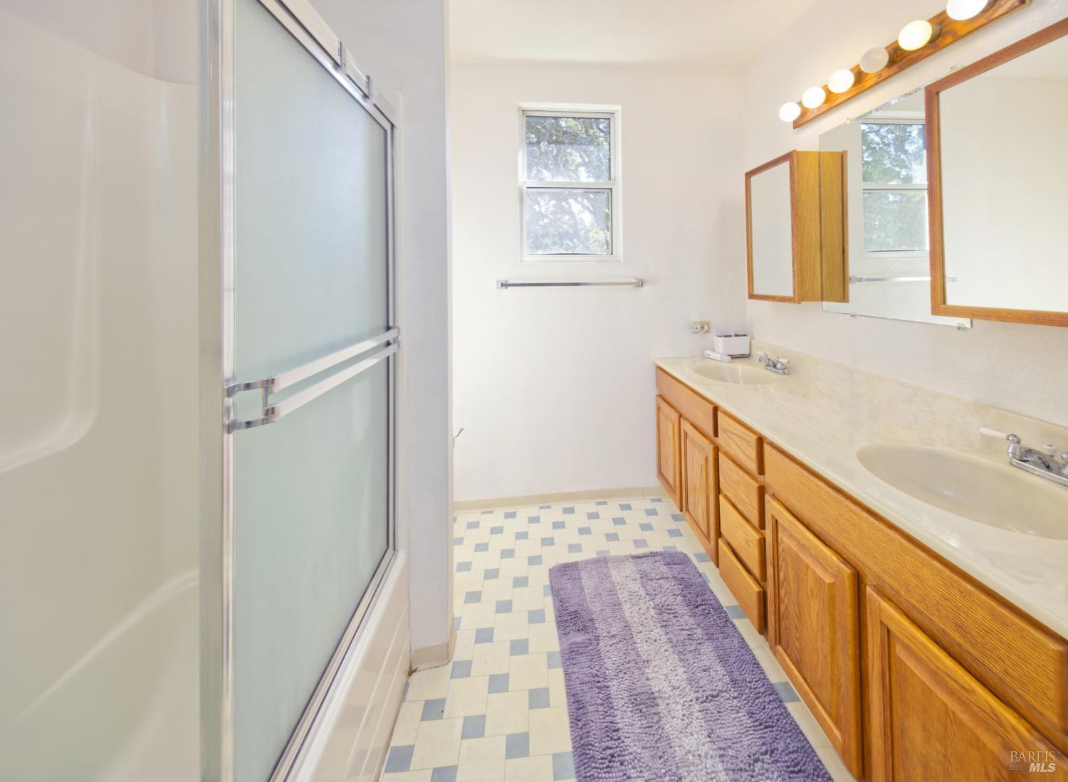 1623 Willowside Road Santa Rosa, CA 95401 - Photo 19 of 47 a bathroom with sink a mirror and a shower