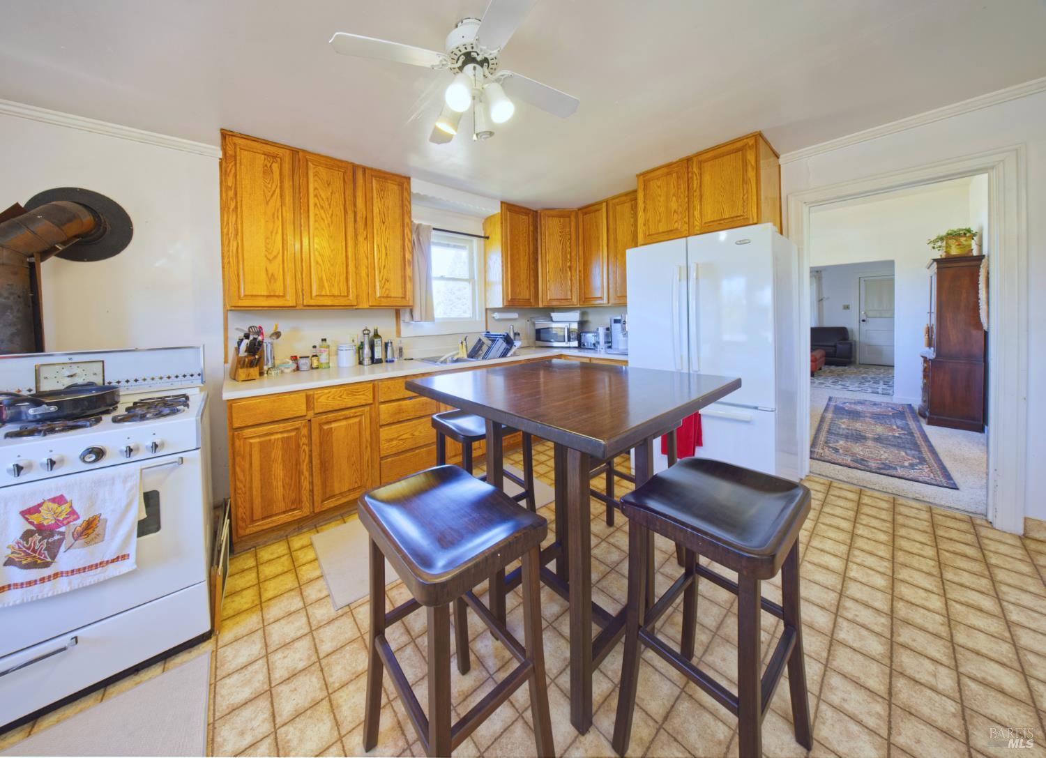 1623 Willowside Road Santa Rosa, CA 95401 - Photo 21 of 47 a room with a table chairs and a refrigerator