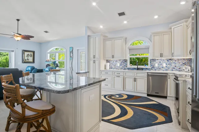 a kitchen with stainless steel appliances a sink a stove and a window