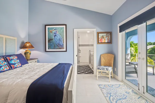 a bedroom with bed and wooden floor