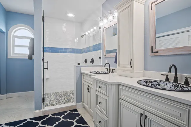 a bathroom with a toilet a sink a vanity and window