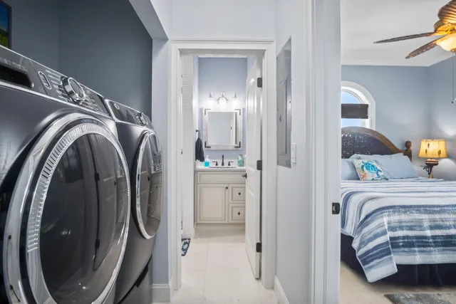 a swimming pool with lawn chairs and wooden fence