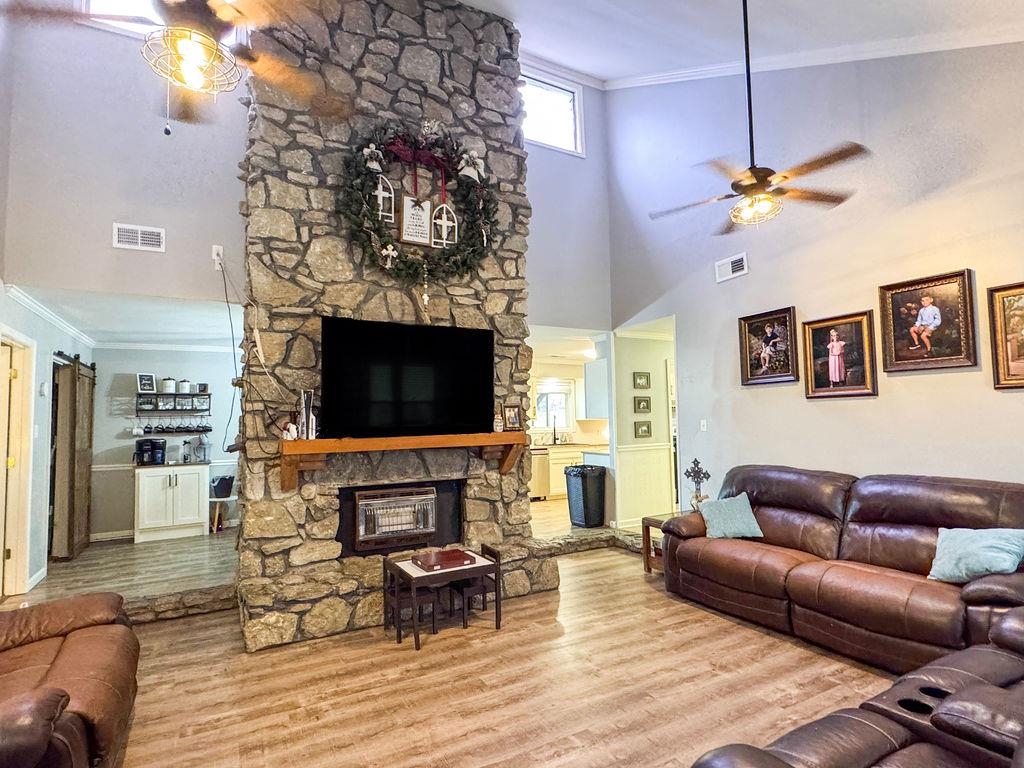 127 Walton Loop Covington, TN 38019 - Photo 6 of 40 a living room with furniture a flat screen tv and a fireplace