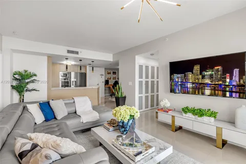 a living room with furniture and flowers