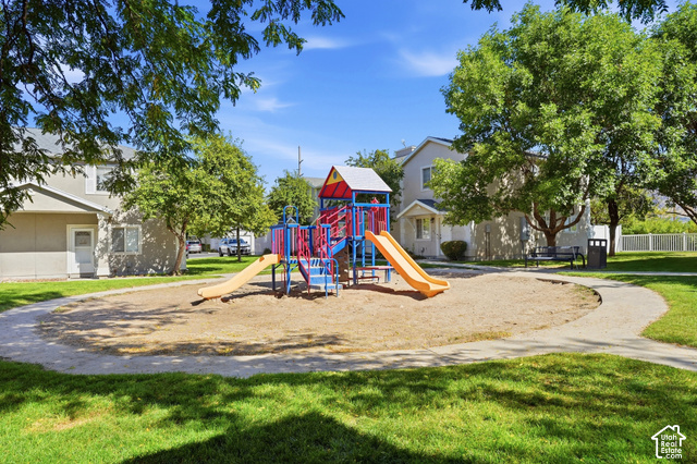 108 Penhurst Place Logan, UT 84341 - Photo 38 of 44 Community playground featuring slides and climbing structures, surrounded by a sand play area, manicured lawns, and mature trees