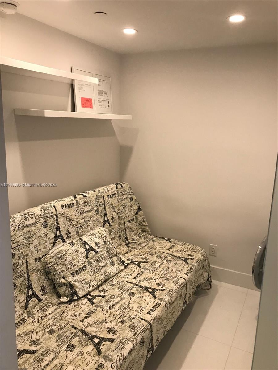 100 Lincoln Road, Unit 719 Miami Beach, FL 33139 - Photo 13 of 50 a bed sitting in a bedroom next to a window