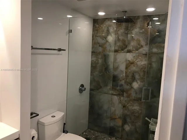 a bathroom with a shower and a toilet
