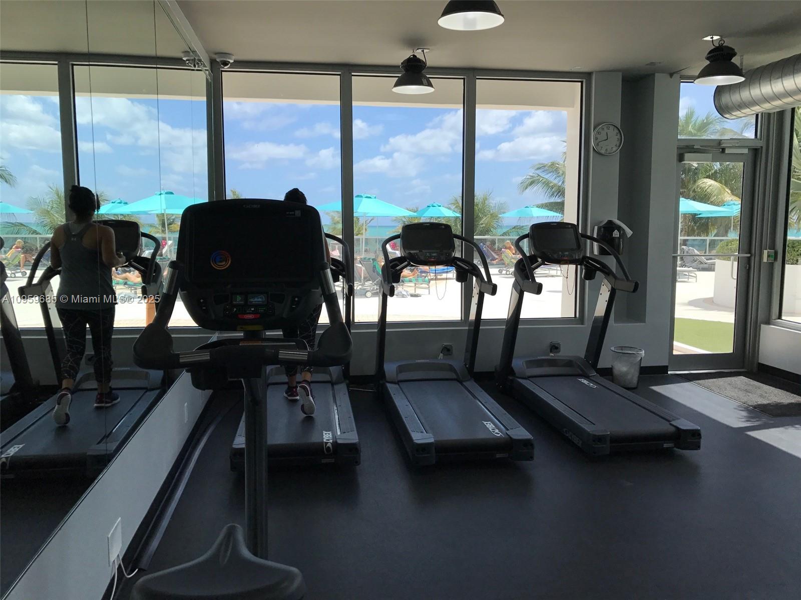 100 Lincoln Road, Unit 719 Miami Beach, FL 33139 - Photo 39 of 50 a room with gym equipment and large windows