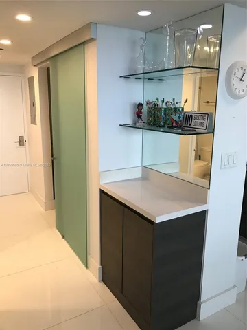 a kitchen with a sink a refrigerator and cabinets