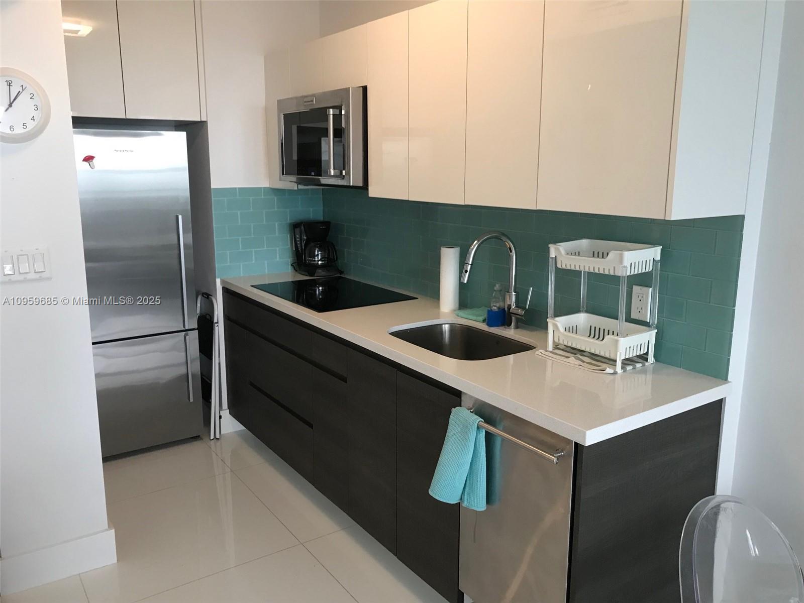 100 Lincoln Road, Unit 719 Miami Beach, FL 33139 - Photo 8 of 50 a kitchen with stainless steel appliances granite countertop a sink a refrigerator and a stove
