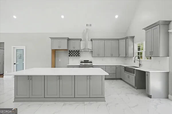 a kitchen with stainless steel appliances a sink stove and cabinets