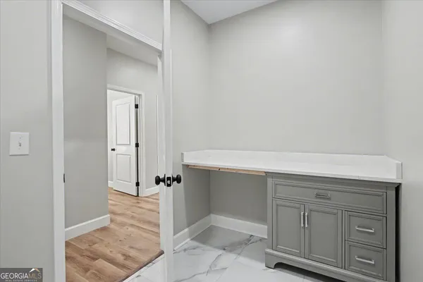 a view of a hallway with wooden shelves