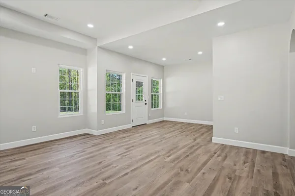 a view of room with window and hardwood floor