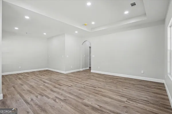a spacious bathroom with double vanity sink a large mirror and a bathtub