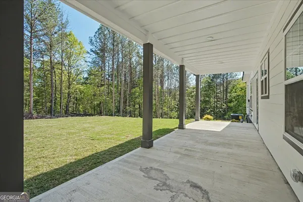 a view of a house with yard and sitting area