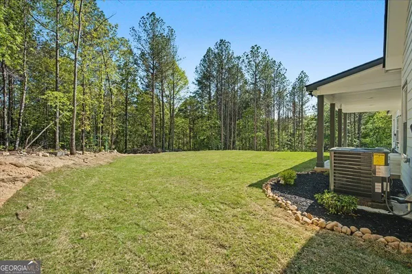 a view of a house with a yard and garage