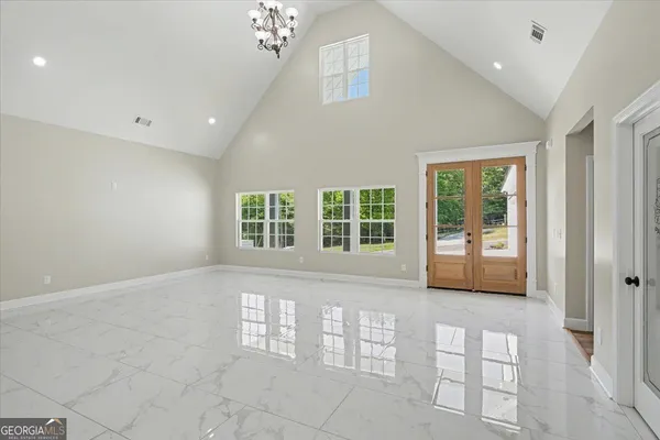 a large white kitchen with a large window