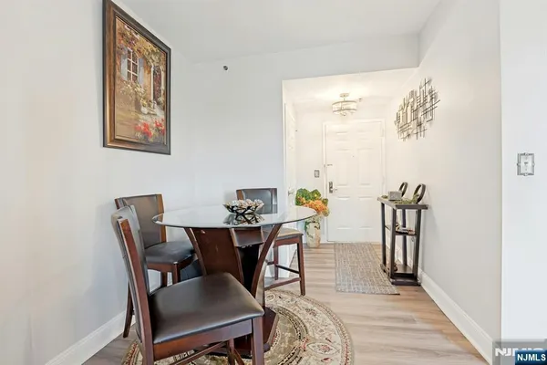 a living room with furniture a chandelier and a mirror