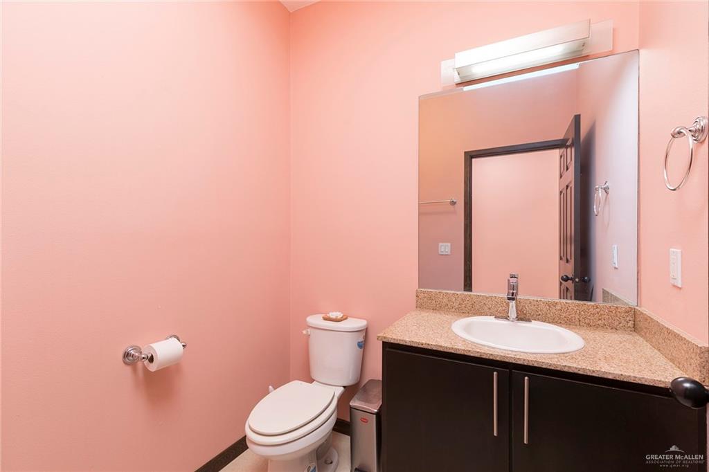 813 Travis Street, Unit 416 Mission, TX 78572 - Photo 11 of 32 a bathroom with a sink and a toilet