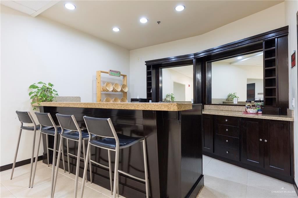 813 Travis Street, Unit 416 Mission, TX 78572 - Photo 20 of 32 a kitchen with a table and chairs in it