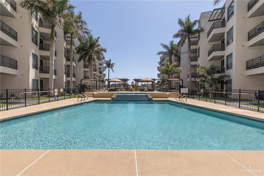 813 Travis Street, Unit 416 Mission, TX 78572 - Photo 24 of 32 a swimming pool with outdoor seating and yard