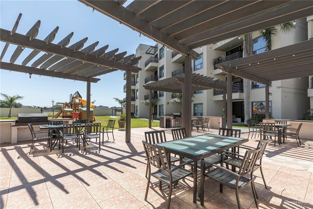 813 Travis Street, Unit 416 Mission, TX 78572 - Photo 4 of 32 a view of a dinning table and chairs in the patio