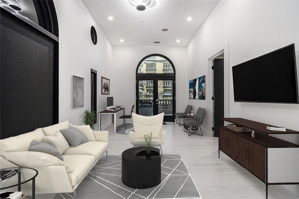 199 14th Street Northeast, Unit 103 Atlanta, GA 30309 - Photo 2 of 32 a living room with furniture and a flat screen tv