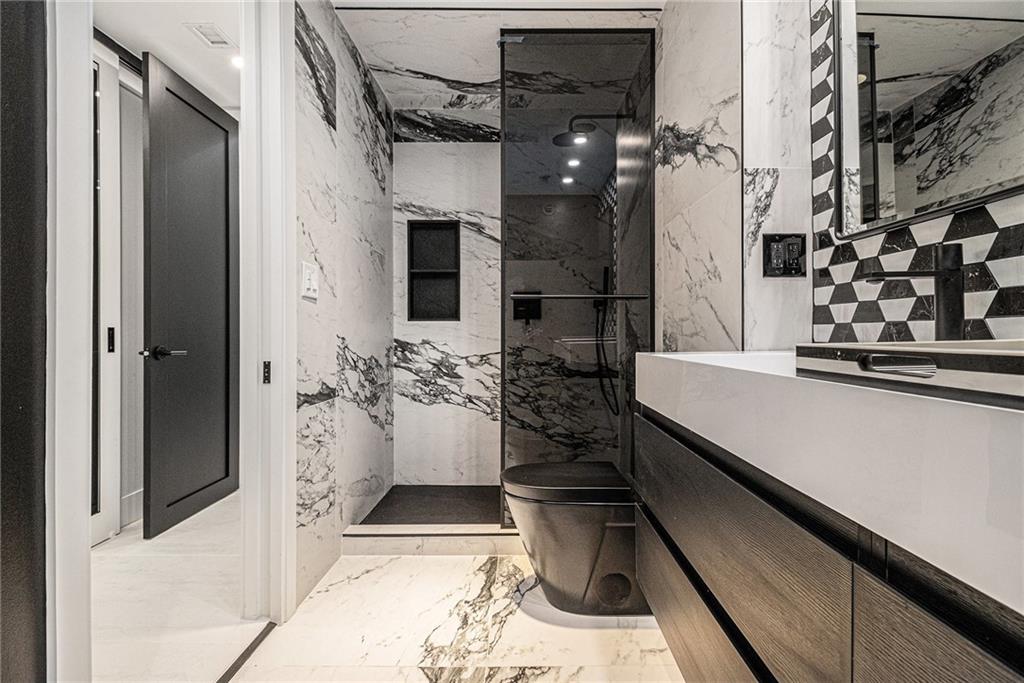 199 14th Street Northeast, Unit 103 Atlanta, GA 30309 - Photo 22 of 32 a bathroom with a bathtub and shower