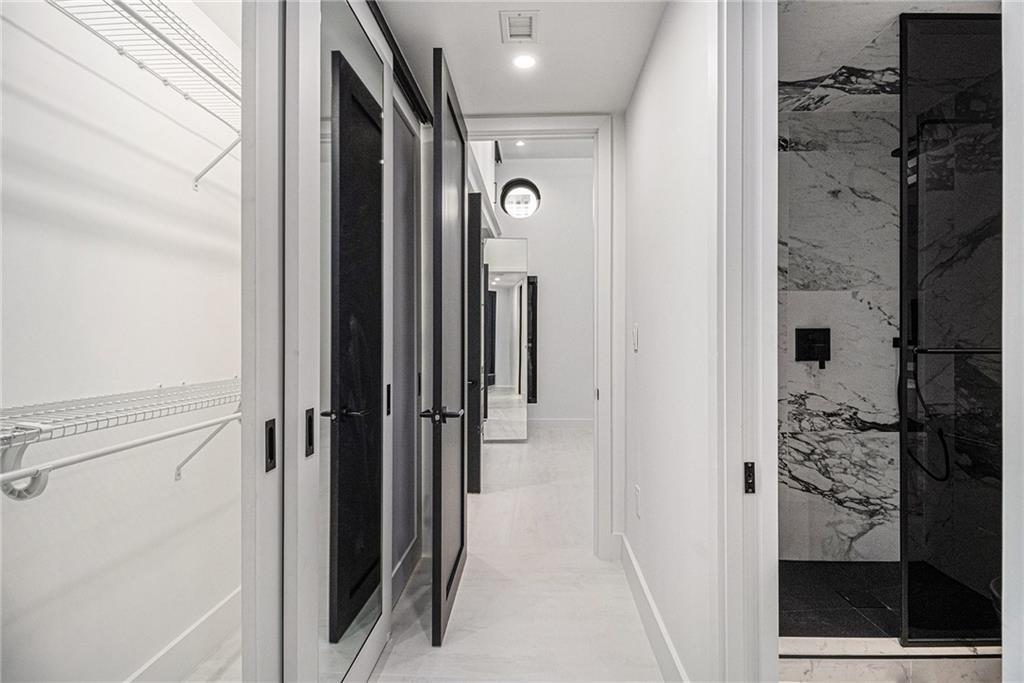 199 14th Street Northeast, Unit 103 Atlanta, GA 30309 - Photo 23 of 32 a view of a hallway with wooden floor and staircase