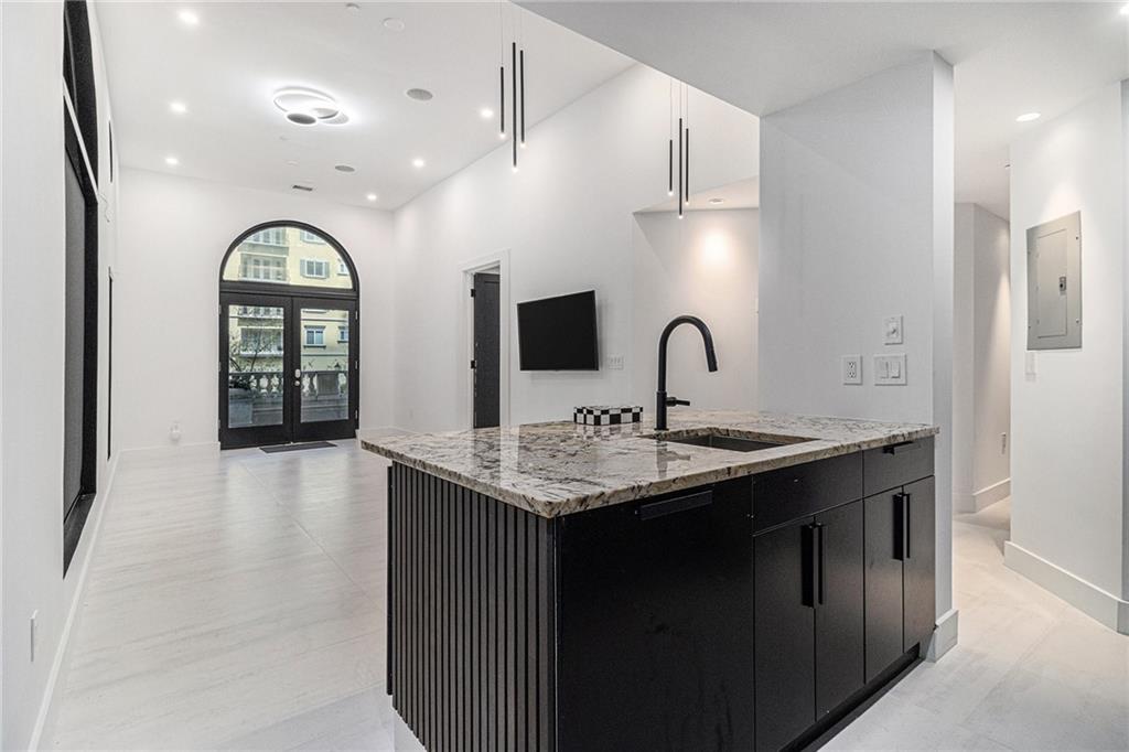 199 14th Street Northeast, Unit 103 Atlanta, GA 30309 - Photo 7 of 32 a kitchen with furniture a sink and large windows