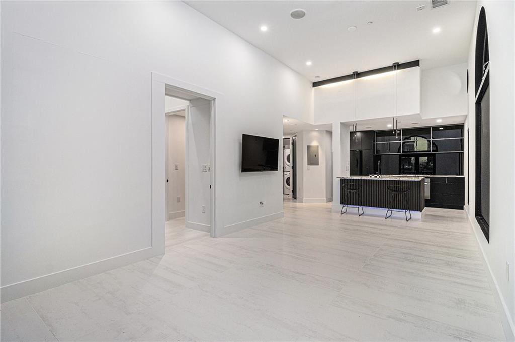 199 14th Street Northeast, Unit 103 Atlanta, GA 30309 - Photo 8 of 32 an empty room with kitchen view