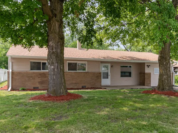 a front view of house with yard and green space