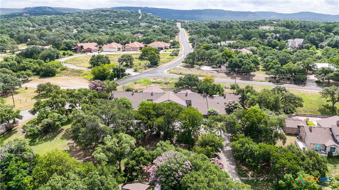 8 Oak Villa Road, Unit G2 Canyon Lake, TX 78133 - Photo 14 of 17 an aerial view of residential houses with outdoor space and trees