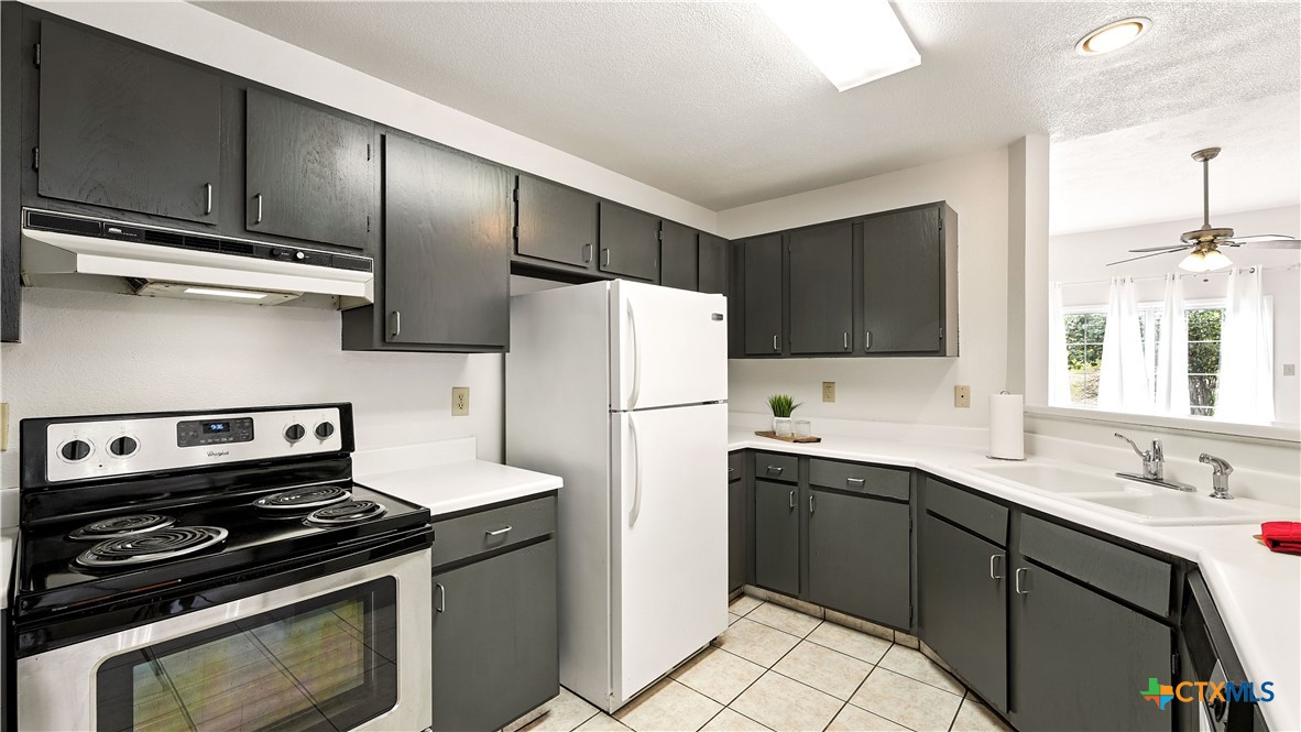 8 Oak Villa Road, Unit G2 Canyon Lake, TX 78133 - Photo 3 of 17 a kitchen with a sink appliances and cabinets