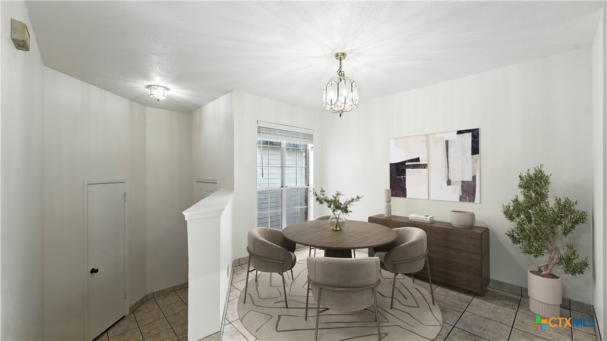 8 Oak Villa Road, Unit G2 Canyon Lake, TX 78133 - Photo 8 of 17 a view of a dining room with furniture and chandelier