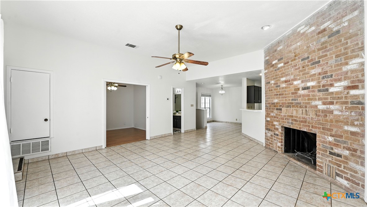 8 Oak Villa Road, Unit G2 Canyon Lake, TX 78133 - Photo 10 of 17 a view of empty room with wooden floor and fireplace